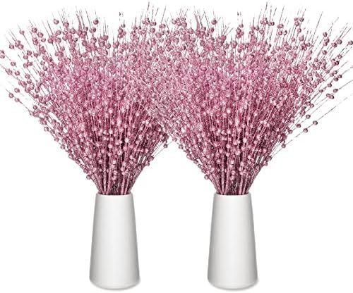 two white vases with pink flowers in them