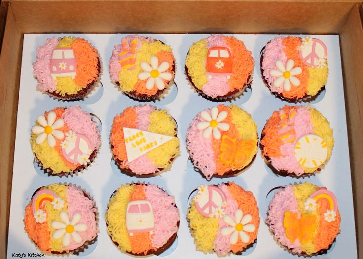 cupcakes decorated with different designs in a box