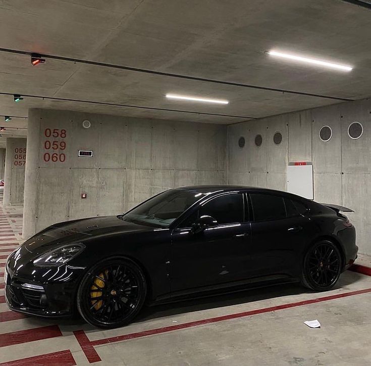 a black sports car parked in a parking garage