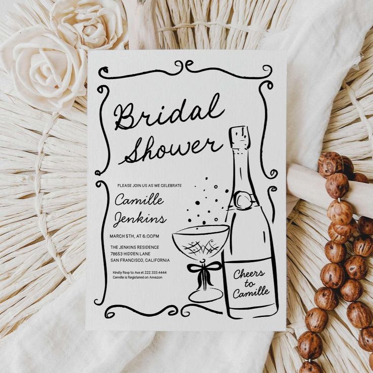 the bridal shower card is sitting on top of some flowers and beads next to it