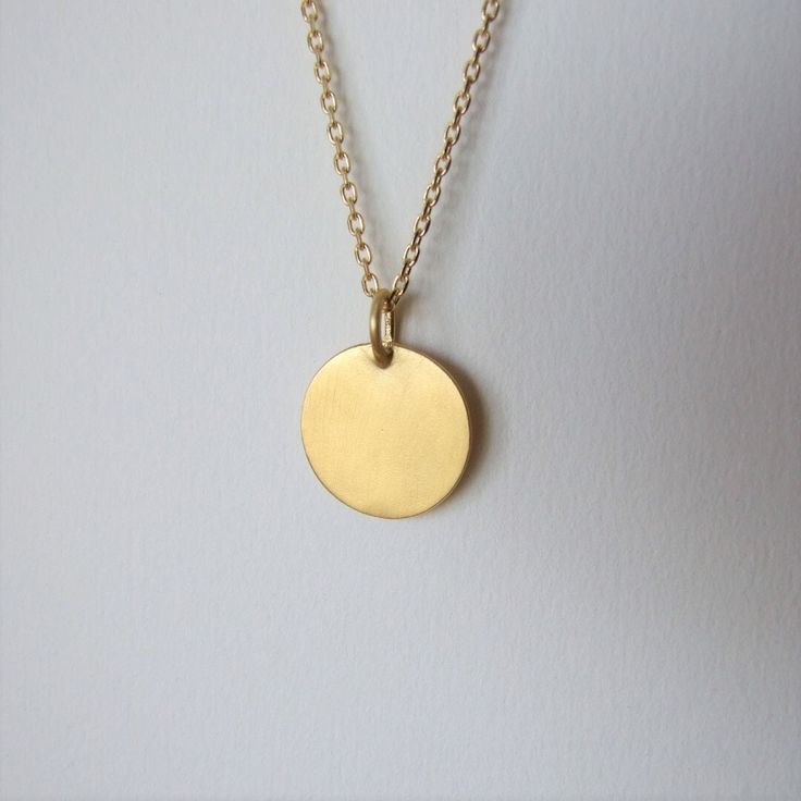 "This minimalistic 14k gold pendant is unisex and a perfect gift for a man. It is made of 14k gold and has an elegant matte finish. The pendant can be ordered by itself or with a chain necklace. You can choose the color of 14k gold of the pendant and the chain necklace will be made of- yellow or white gold. I plate the white gold with rhodium as common in white gold jewelry The diameter of the round pendant is 0.62 inches ( 1.6 cm ).  If you decide to order the pendant with the chain necklace yo Minimalist Medallion Jewelry For Everyday, Minimalist 14k Gold Filled Medallion Necklace, Gold Circle Minimalist Charm Necklace, Minimalist Gold Circle Charm Necklace, Minimalist Gold Plated Oval Pendant Charm Necklace, Minimalist Engraved 14k Gold Filled Necklaces, Minimalist 14k Gold-filled Medallion Necklace, Minimalist Recycled Gold Medallion Jewelry, Minimalist Circle Charm Gold Necklace