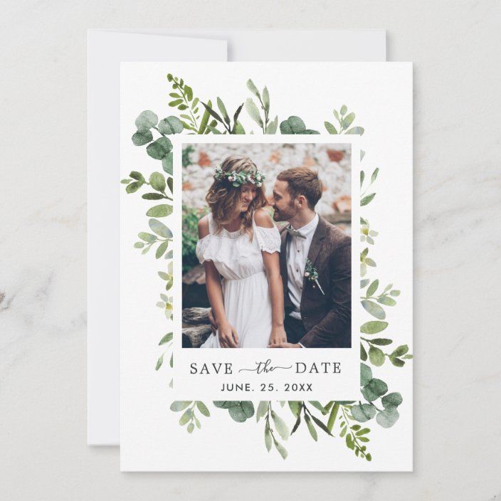 a wedding save the date card with greenery