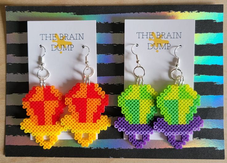 the earrings are made out of legos and have different designs on them, including one that says the brain dump