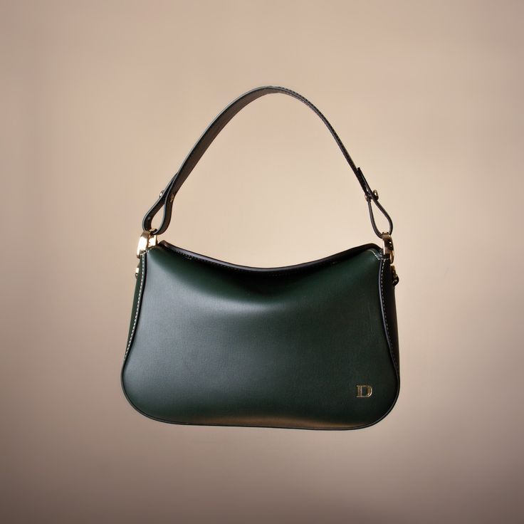 Discover the Hold Bag: a chic, small top-handle bag that perfectly encapsulates a blend of classic elegance and minimalist design. Crafted with smooth leather, this boxy-style accessory features a rounded flap secured by a magnetic closure, ensuring your essentials are safe and easily accessible. The combination of an adjustable strap and a sleek top handle offers versatile carrying options. FIT & SIZE Dimensions 16.51 cm x 25.4 cm x 10.16 cm (Short Handle 15.24 cm; Adjustable Long Pendant: 55.8 Hand Crafted Gifts, Long Pendant, Handle Bag, Classic Elegance, Small Tops, High Quality Leather, Magnetic Closure, Smooth Leather, Top Handle