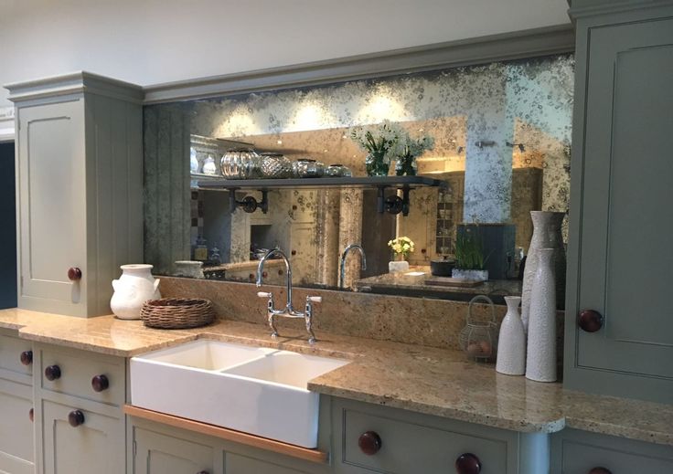 a kitchen with marble counter tops and gray cabinets