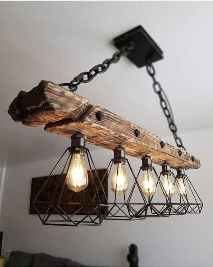 the light fixture is made out of wood and has five bulbs hanging from it's chain