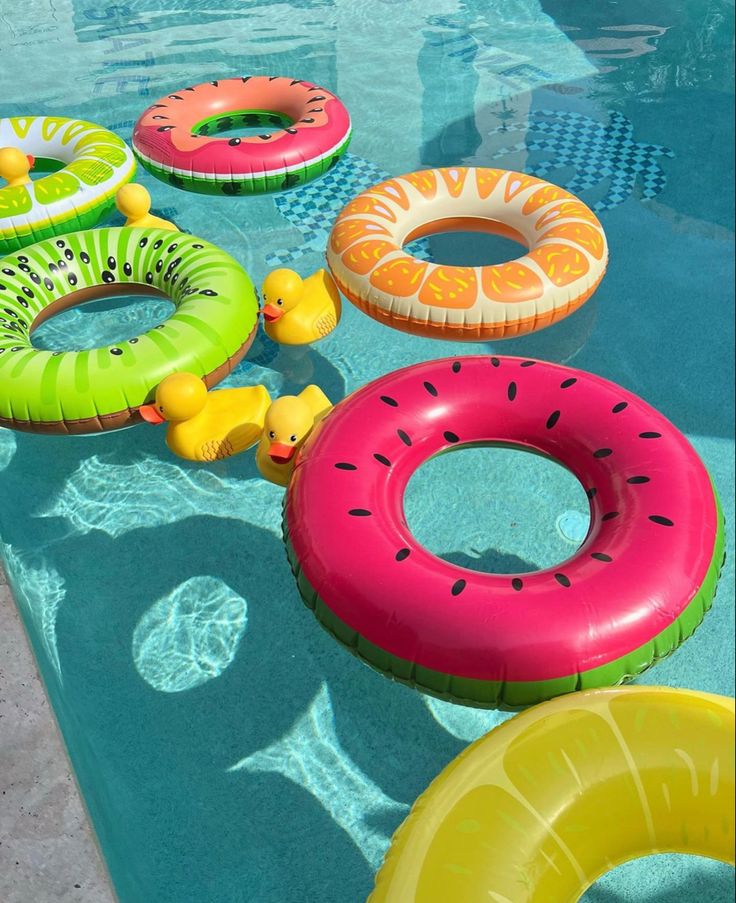 an inflatable pool float set up on the edge of a swimming pool with rubber rings around it