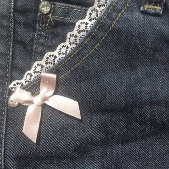 a pair of jeans with a pink bow on the side and lace around the waist