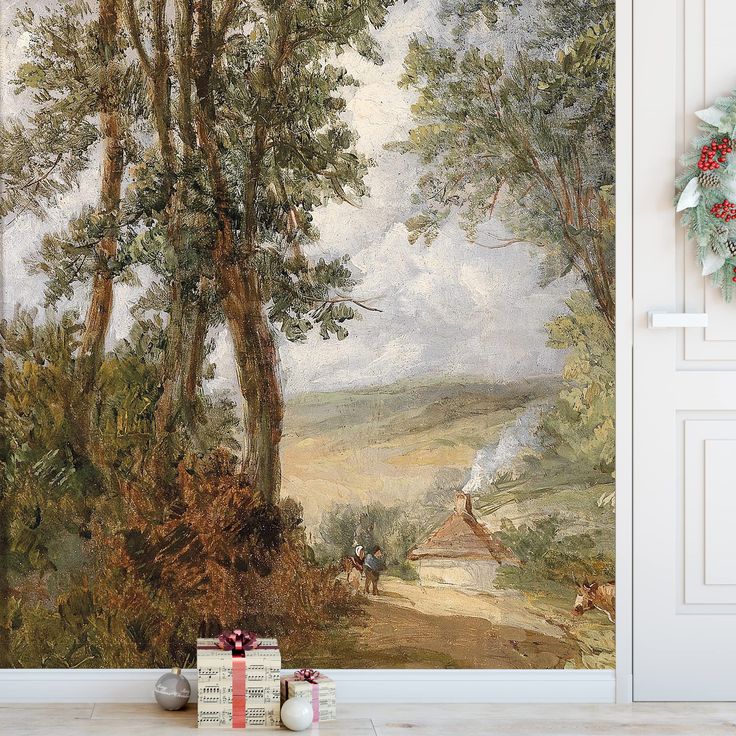 a painting on the wall next to a christmas wreath