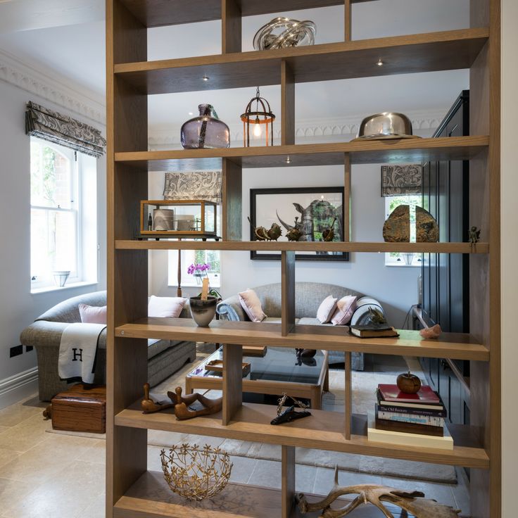 a living room filled with lots of wooden shelves