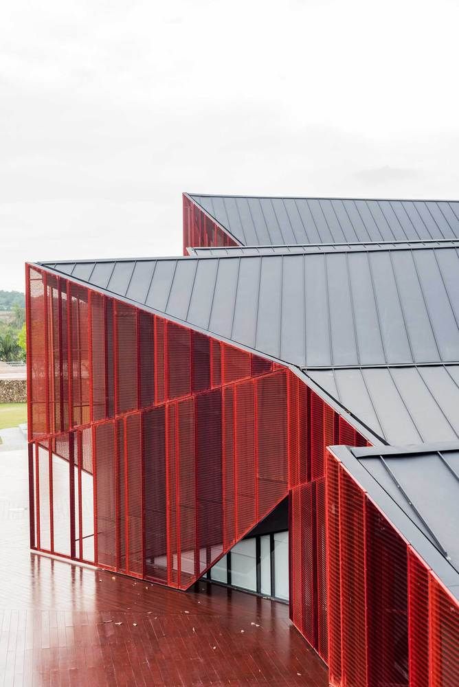 two red buildings with metal roofing and windows