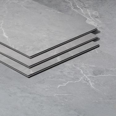 three pieces of metal sitting on top of a gray floor