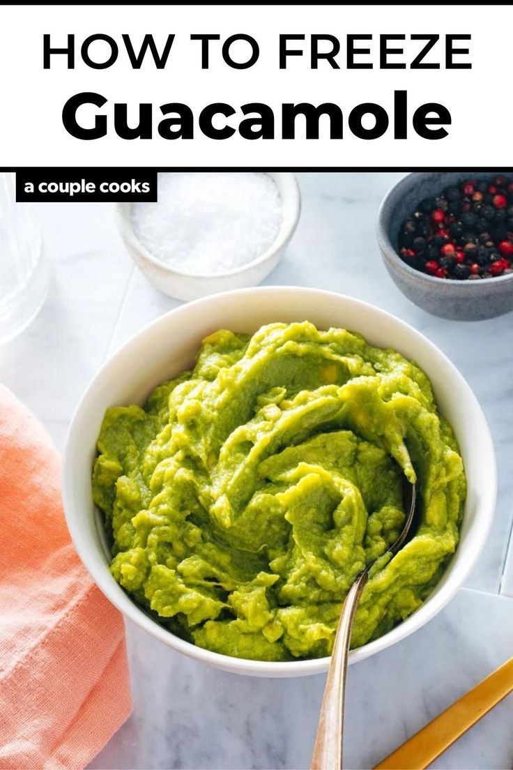 a bowl filled with guacamole next to other ingredients