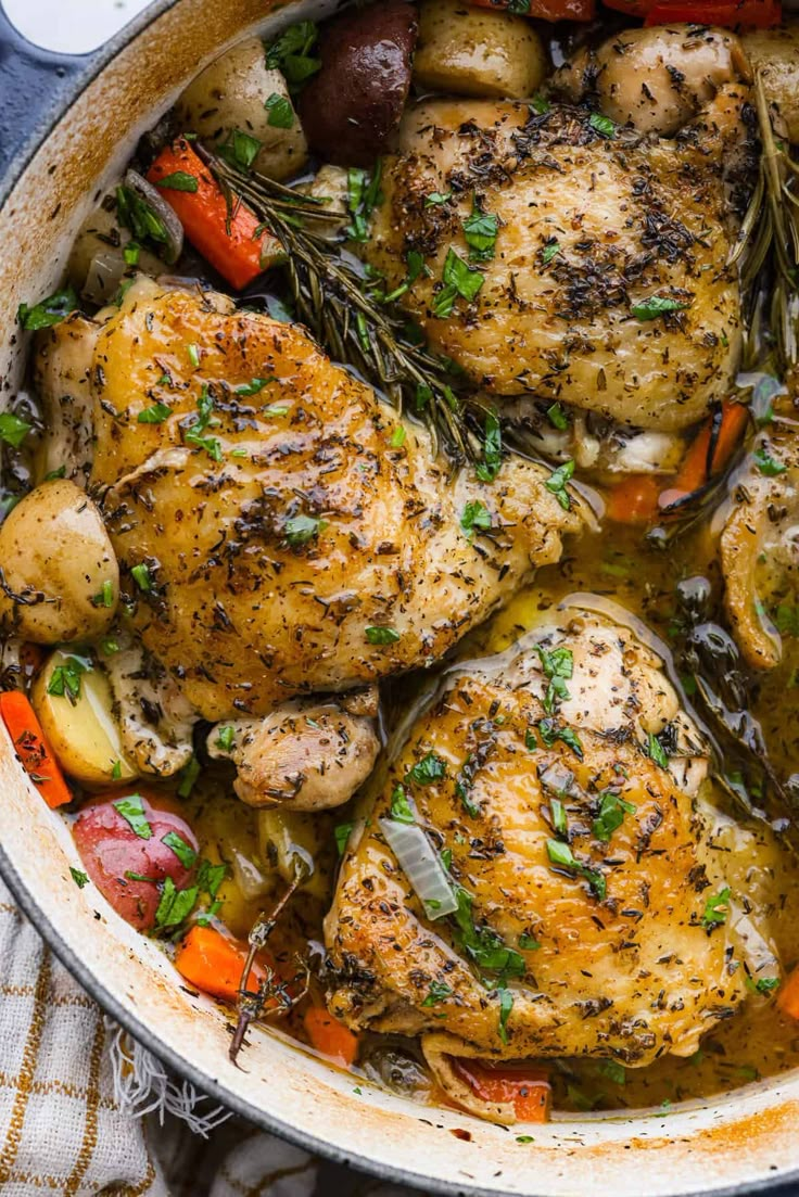 chicken and potatoes in a pot with herbs