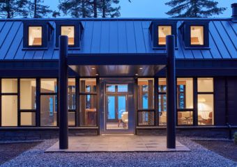 the front entrance to a modern home at dusk