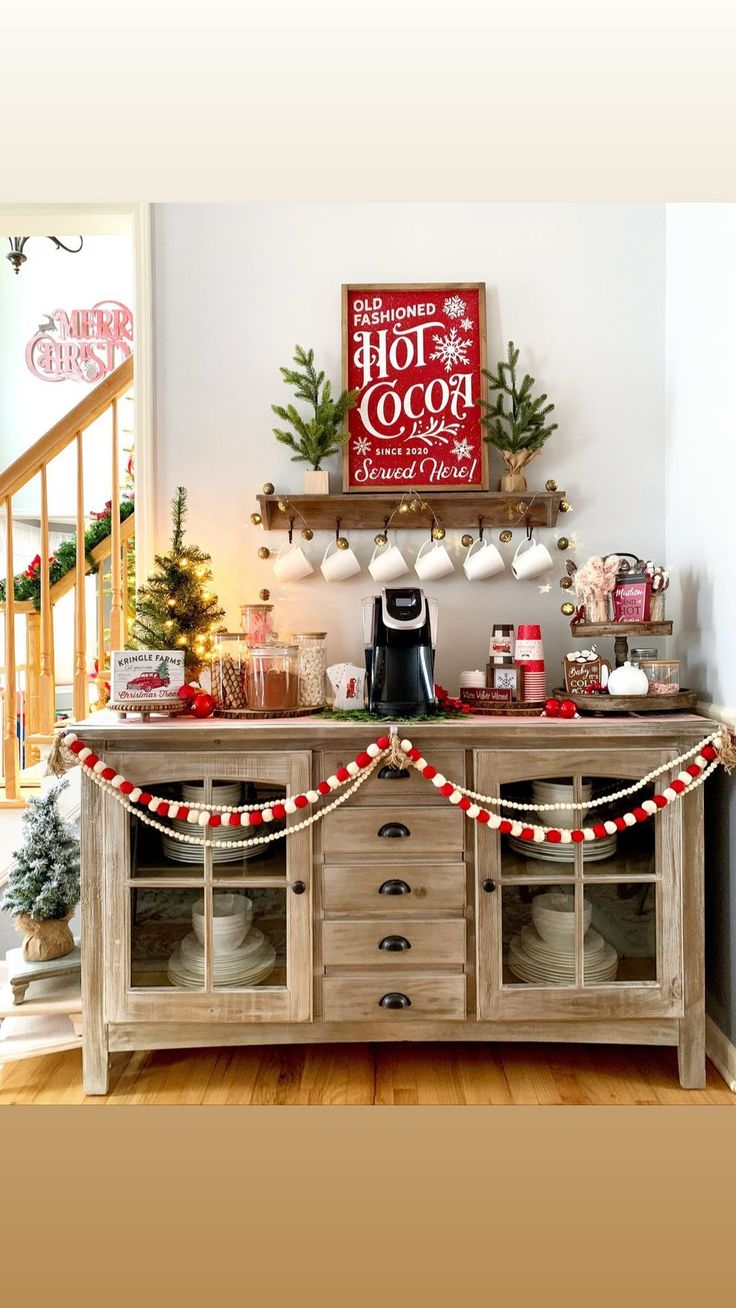 a buffet table with christmas decorations on the top and lights hanging from it's sides