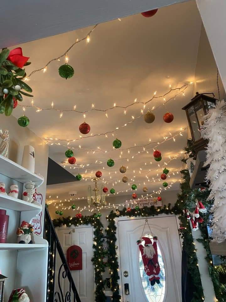 christmas decorations and lights hang from the ceiling