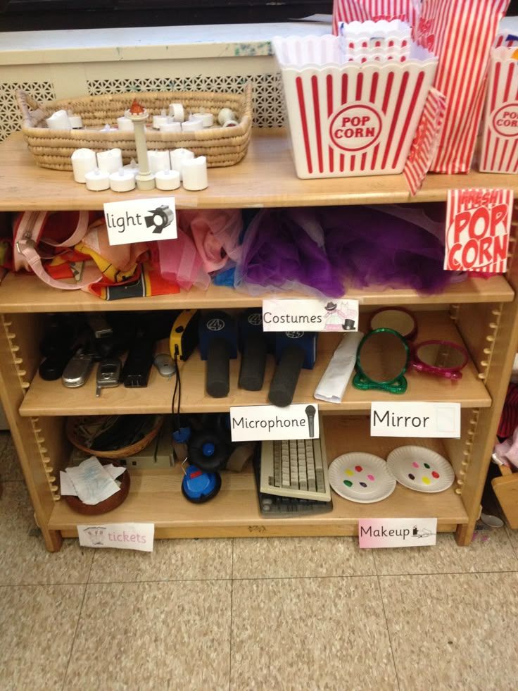 a shelf filled with lots of different items on top of a floor next to a tv