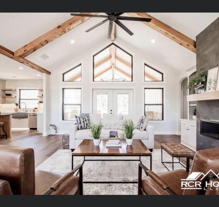 a living room filled with furniture and a ceiling fan