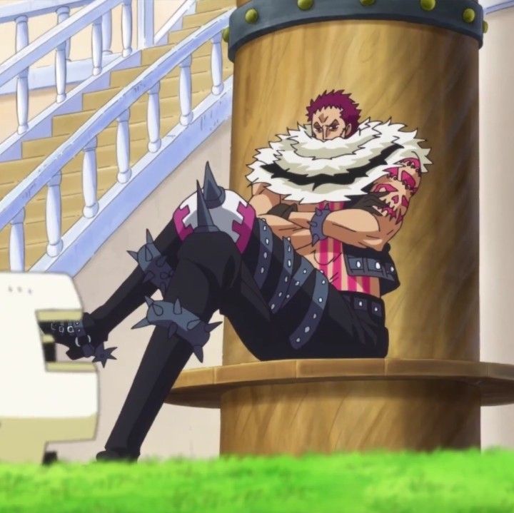 an anime character laying on the ground next to a giant object in front of stairs