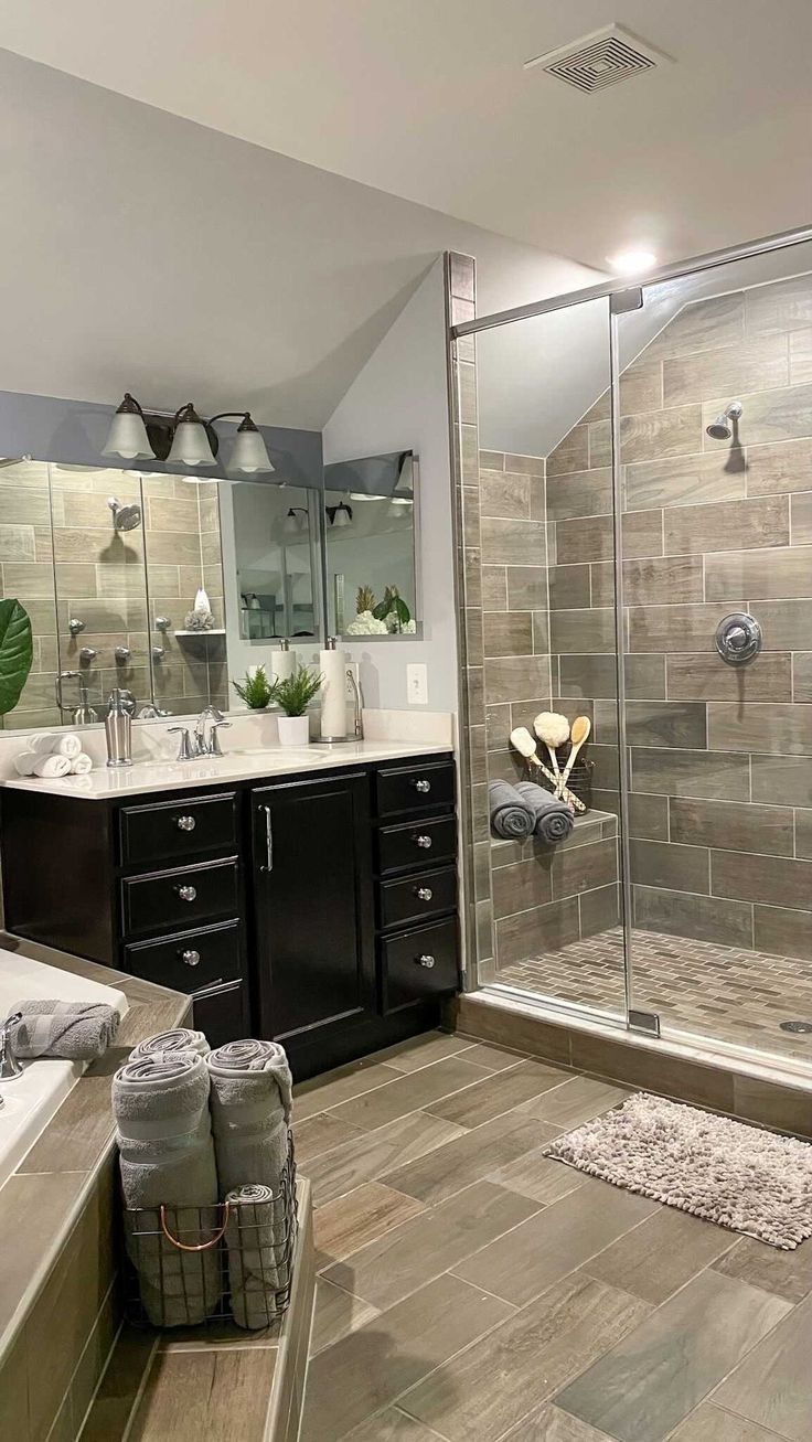 a bathroom with a walk in shower next to a bathtub and sink under mirrors