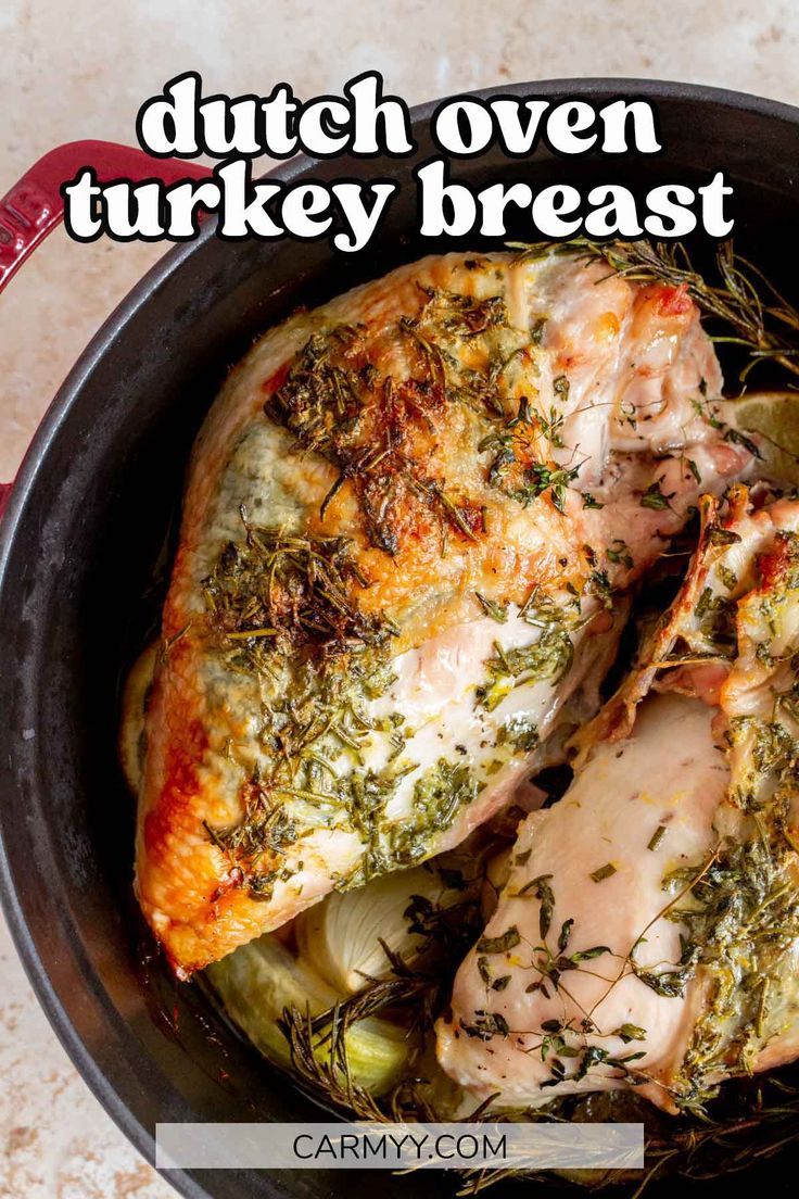 a pan filled with chicken and vegetables on top of a table