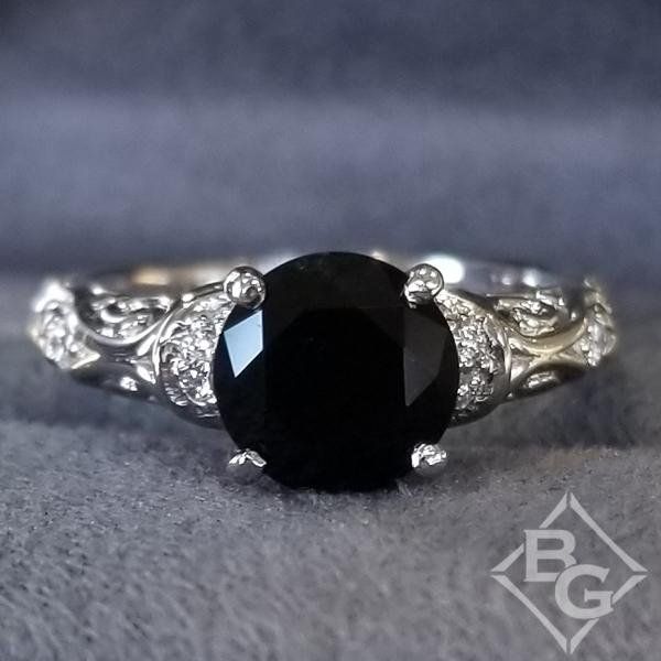 a black and white diamond ring with filigrees