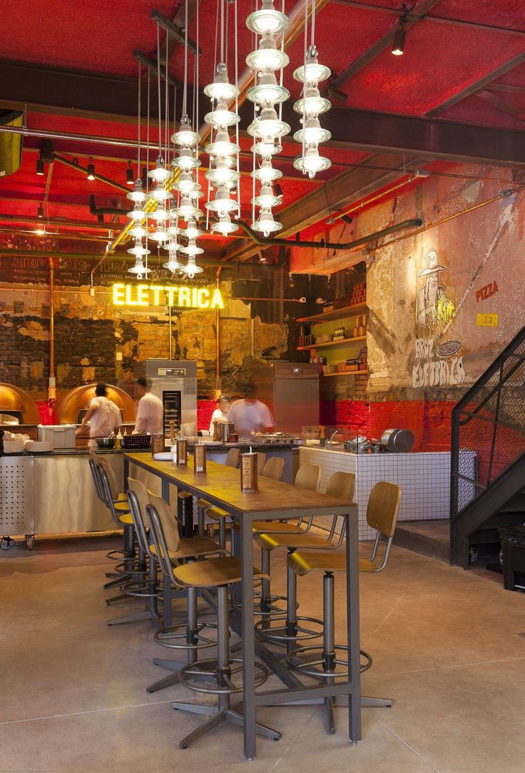 a restaurant with many lights hanging from the ceiling