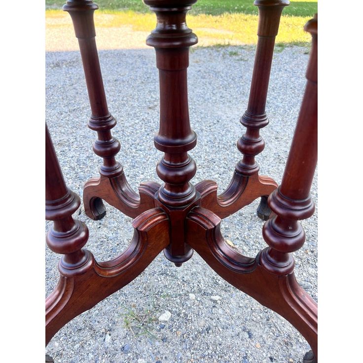 an antique wooden table with four candlesticks