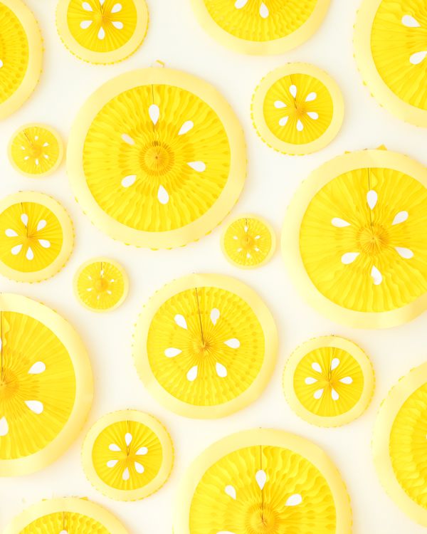 several slices of yellow fruit are arranged in a pattern on a white tablecloth,