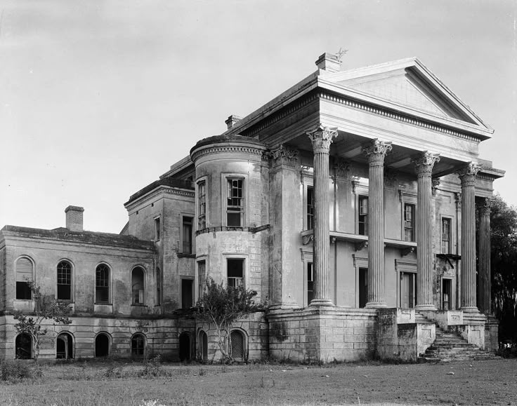 an old building with columns and pillars on the front