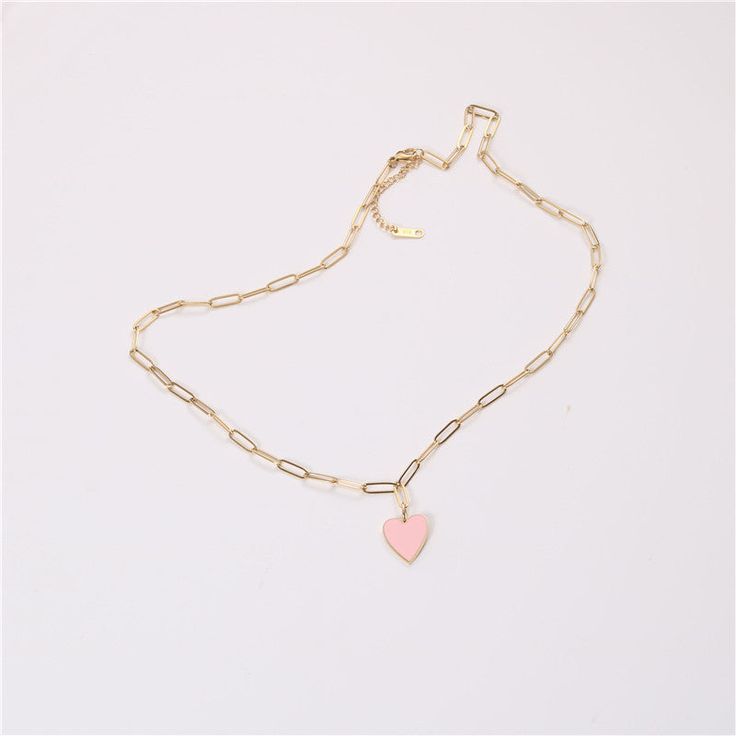 Introducing our stunning Pink Heart Pendant with paperclip necklace, the perfect addition to any jewelry collection. This necklace is designed with a beautiful pink enamel heart pendant that will capture the attention of everyone around you. The pendant hangs from a stylish paperclip chain that is 18k gold plated, giving it a luxurious and high-end look. Not only is this necklace stylish, but it is also practical. It is tarnish-resistant, so you can wear it for years to come without having to wo Trendy Pink Short Chain Necklace, Pink Charm Necklaces For Everyday Wear, Trendy Pink Necklace With Heart Charm, Trendy Rose Gold Heart Charm Necklaces, Pink Chain Necklace For Valentine's Day Gift, Pink Charm Necklace For Everyday, Trendy Pink Clavicle Chain Necklace, Pink Necklace For Everyday And Valentine's Day, Pink Dainty Heart Necklace With Adjustable Chain