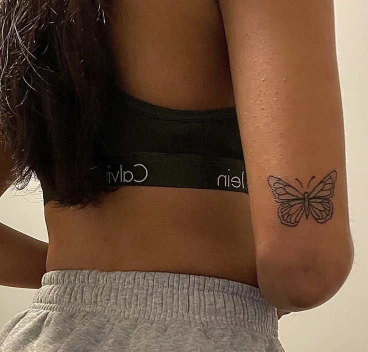 a woman with a butterfly tattoo on her left arm and the word calvi written in cursive writing