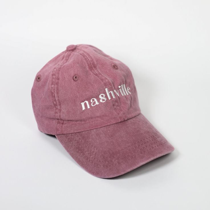 Our Nashville Embroidered Dad Hat - the perfect accessory for showing off your love for Music City in style! Whether you're a local or a visitor, this hat is designed to show off your love of Nashville in a comfortable, modern design. This hat is a faded vintage-style maroon red cap that's pigment-dyed to give it a worn-in look. The design is embroidered with white thread. To adjust the size of this hat, there's a convenient brass clasp closure and an interior pocket to hide the extra material from making it tighter. Every Tay Dunworth hat features a custom, exclusive design and is embroidered in-house in St. Petersburg, FL. Additional Details * Sizing: One size fits most adults * Material: 100% cotton twill * Hat Structure: Unstructured * Hat Profile: Low * Hat Closure: Self-fabric slide Love For Music, Mint Green Sweater, Preppy Plaid, Christmas Headband, Stretch Headband, Red Cap, Maroon Red, Music City, Embroidered Hats