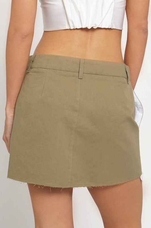 This Khaki Exposed Pocket Raw Edge Mini Skirt is the perfect addition to your wardrobe. Crafted from durable fabric, it features an exposed pocket and raw edge mini design, adding a stylish touch to your look. It's the ideal skirt for creating a fashionable look. Fabric & fit: Model is wearing size Small. Cotton Mini Skirt With Pockets, Cotton Mini Skirt With Belt Loops, Cotton Mini Bottoms With Side Pockets, Mini Cotton Cargo Skirt With Pockets, Cotton Mini Skort With Belt Loops, Relaxed Fit Mini Skort With Pockets, Relaxed Mini Skort With Pockets, Cotton Skirt With Pockets, Short Length, Summer Denim Mini Skirt With Side Pockets