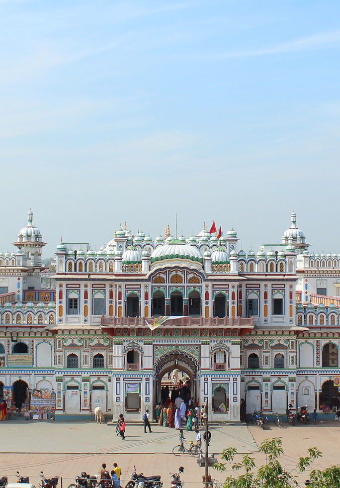 a large white building with lots of people around it