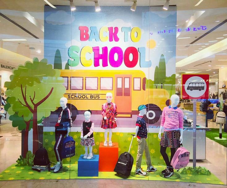 the back to school display features mannequins and suitcases