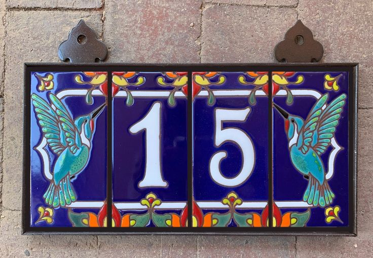 a blue house number with a bird on it