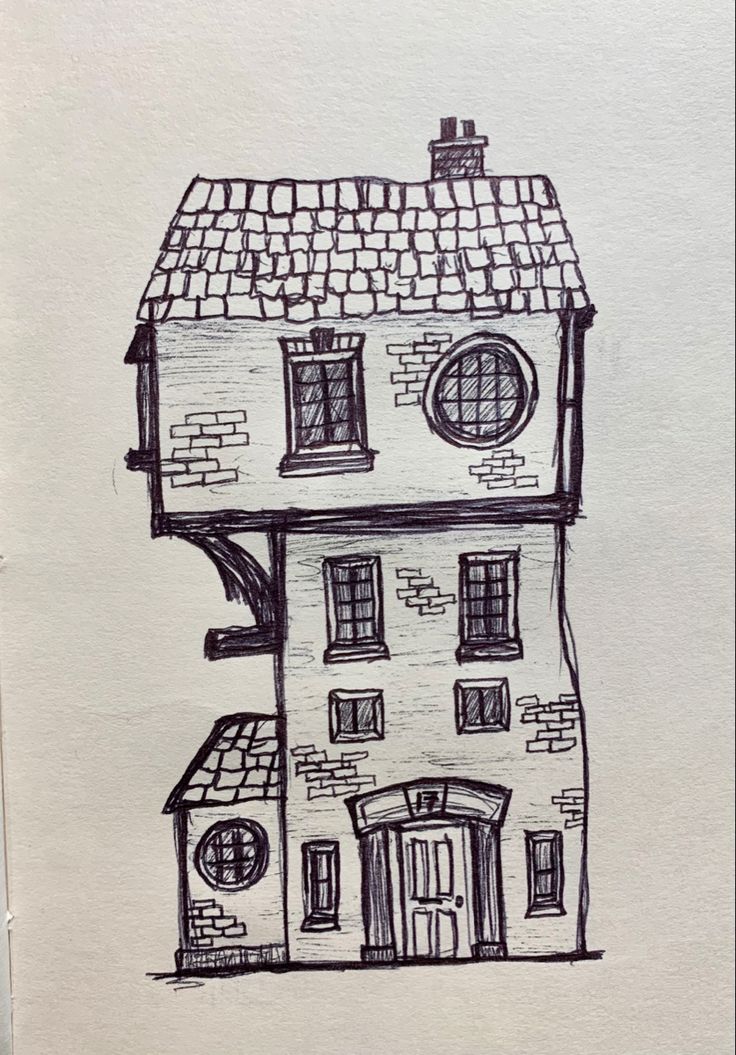 a drawing of a house with windows and a door in the front, on paper