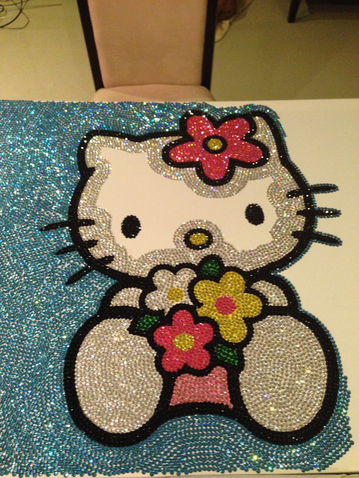 an image of a hello kitty with flowers on it's back and sequins