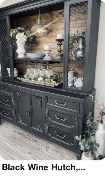 a black wine hutch sitting on top of a wooden floor