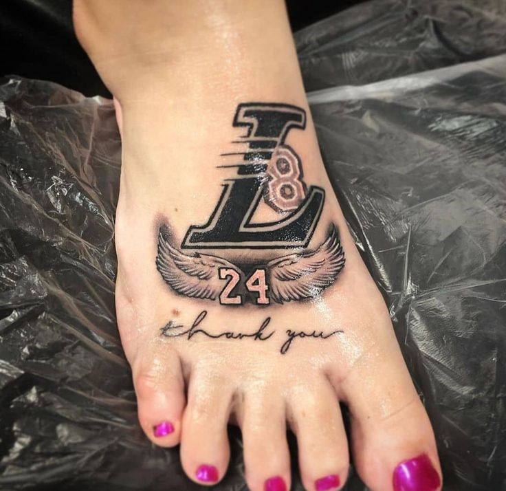 a foot with a tattoo that reads 24 thank you