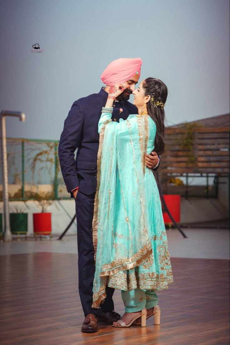 a man and woman standing next to each other on a wooden floor