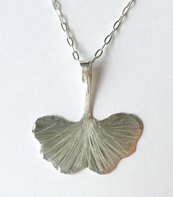 "Hand forged Sterling silver or brass etched and engraved Artisan Gingko leaf necklace measuring 1\"x1\" suspended on a sterling silver or gold filled chain." Unique Etched Sterling Silver Necklace, Silver Etched Nature-inspired Necklaces, Nature-inspired Silver Etched Necklaces, Nature-inspired Sterling Silver Etched Jewelry, Nature-inspired Etched Sterling Silver Jewelry, Nature-inspired Stamped Sterling Silver Jewelry, Nature-inspired Engraved Sterling Silver Necklace, Etched Silver Nature-inspired Jewelry, Etched Nature-inspired Silver Jewelry