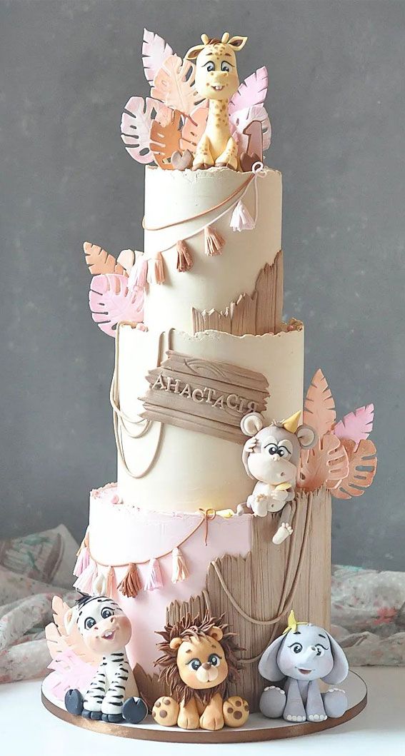 a three tiered cake with animals on it