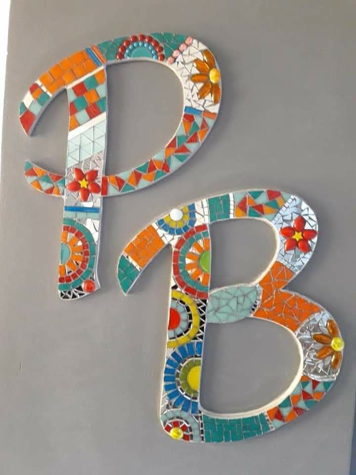 the letters b and c are made out of mosaic tiles, with flowers on them