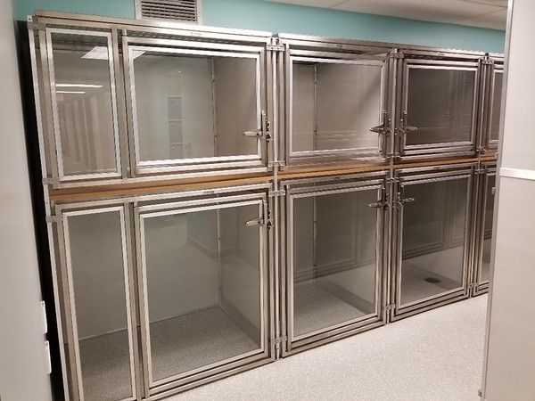 several metal lockers lined up against the wall in an empty room with blue walls