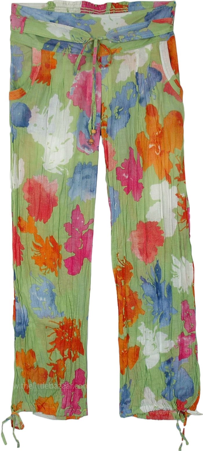 Bring vibrant floral notes to the summer with these green pastel cotton beach pants in crinkled cotton voile. Perfect for lounging around by the pool or the beach, these comfy pants have a fabric belt and an elastic at the back of the waist and drawstrings on the ankles to convert these into harem pants. #tlb #SplitSkirtsPants #Misses #Pocket #beachwrap #SheerPants #BeachPants #PoolPants Summer Beach Pants With Floral Print, Floral Print Summer Pants For Beach Season, Summer Floral Print Beach Pants, Summer Floral Print Pants For Beach Season, Floral Print Beachwear Pants For Summer, Beach Cotton Pants With Floral Print, Floral Print Beachwear Pants For Spring, Tropical Green Bottoms With Elastic Waistband, Tropical Style Summer Pants With Elastic Waistband