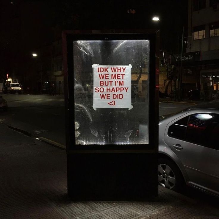 a bus stop with a sign on it that says, i ok why we met and happy we did