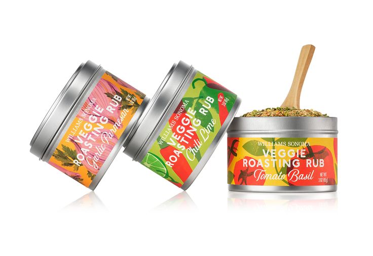 two tins filled with different types of food and a wooden spoon in each one